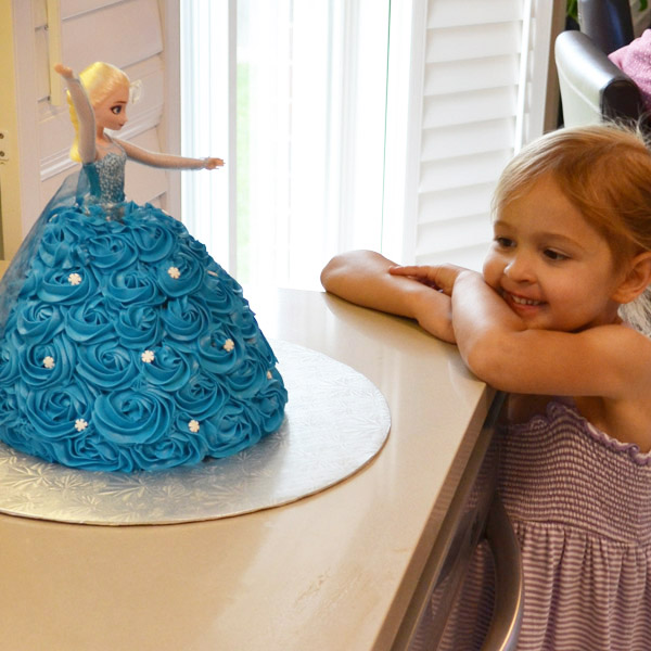 Daughter in awe of Elsa Doll Cake made by Mama