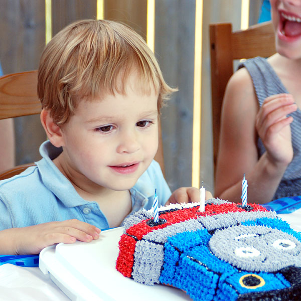 Son in awe of Thomas the Train Cake made by Mama